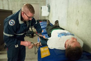 BYU EMTs train on other students in staged scenarios like this one, where a cardboard compactor machine 'blew up' and injured some students. Photo by Natalie Stoker