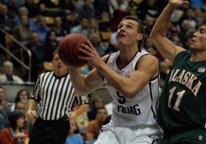 Kyle Collinsworth drives the lane against Alaska Anchorage. The Cougars won the game, ____. Photo by Maddi Dayton