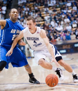 Jackson Emery dribbles past an Air Force defender in a game in 2011. BYU defeated Air Force 76-66. Photo by Chris Bunker.