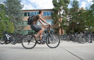 A student rides a bike on campus. As parking policy changes, more students are finding other methods of transportation. (Chris Bunker)