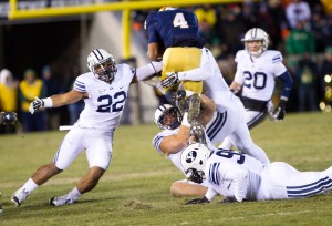 Manoa Pikula and two other BYU defenders take down a Notre Dame running back during Saturday's game in South Bend. Photo by Sarah Hill