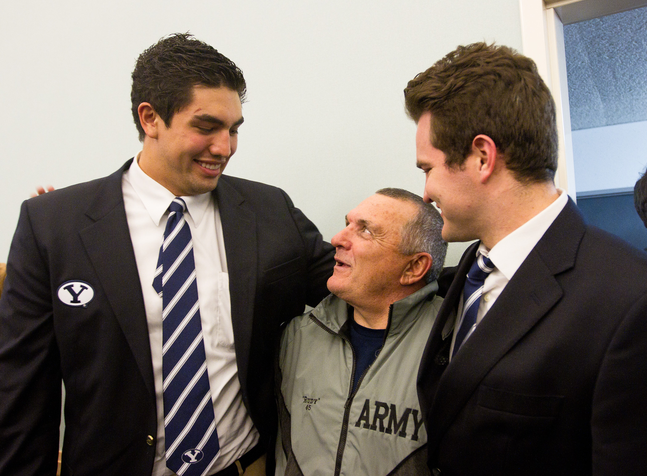 BYU football players Bronson Kaufusi and Skye Povey talk with Notre Dame legend Rudy Ruettiger at the team's traditional pregame fireside Friday, Nov. 22, 2013. (Photo by Sarah Hill)