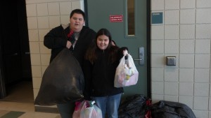 Katie and her brother Michael delivering eight trash bags full of clothes and toys to a Burundi population in 2012. Photo courtesy Janee' Livingston. 