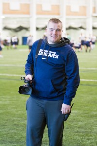 Brayden Woodall poses with his camera after shooting film for the football team. Photo by Sarah Hill.