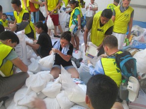 Missionaries and other volunteers wear Mormon Helping Hands vests as they pack goods at the Department of Social Welfare and Justice in Tacloban. (Photo courtesy LDS Newsroom)