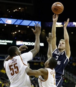 Tyler Haws gets past two Texas defenders to put up a shot during the second half of the game. BYU won 86-82. Photo courtesy AP Photo/Charlie Riedel.