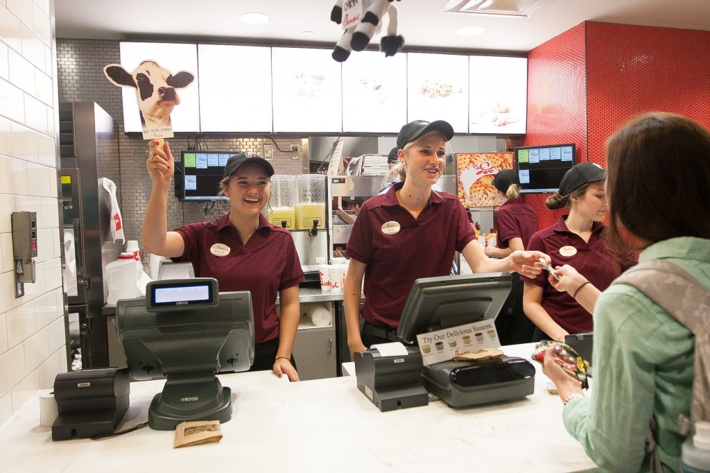 Sarah Lyman, center, helps a customer at the new Chick-fil-A in the Wilkinson Center during Thursday's grand opening celebration on Thursday, Sept. 5. The grand opening came after years of student requests that the restaurant come to campus. (Photo by Sarah Hill)