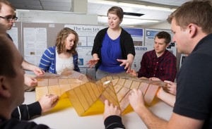 Graduate student Shannon Zirbel works with BYU engineering students to design compact solar panels using origami techniques.