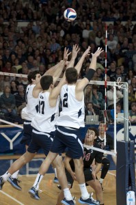 The Cougar volleyball players go up for the triple block against the Stanford Cardinal. Photo by Natalie Stoker.