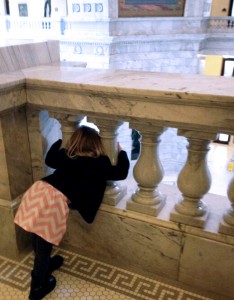 A small girl peeks out into the Utah Capitol Rotunda as the 2014 Legislature opens.