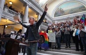 Troy Williams, a local LGBT organizer, speaks to a crowd of supporters of gay marriage as they gathered to rally and deliver over 58,000 petition signatures in support of gay marriage to Utah Governor Gary Herbert at the Utah State Capitol Friday, Jan. 10, 2014 in Salt Lake City. (AP Photo/Steve C. Wilson)