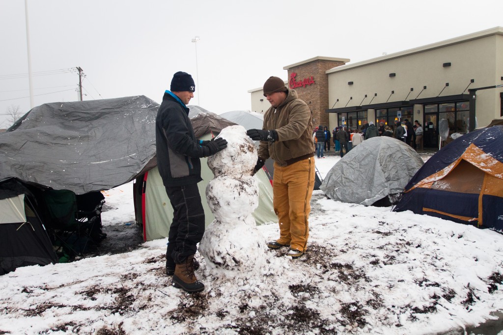 BYU student Jason Prete build a snowman next to their tent to keep themselves busy while they camp out for the grand opening of Chick-fil-A. 