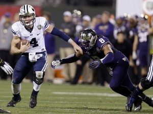 Taysom Hil runs past a Washington defender during the first half of the Fight Hunger Bowl on Dec. 27 in San Francisco. Photo Courtesy AP Photo/Marcio Jose Sanchez.