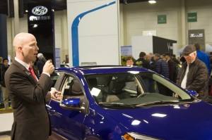 A Toyota spokesperson demonstrates the features of the new model of the Toyota Corolla at the 2014 Utah International Auto Expo.