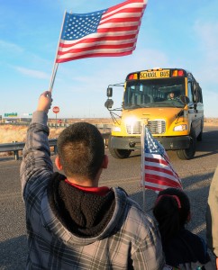 Supporters of Berrendo Middle School hold welcome backs signs and balloons while waving American flags and yellow ribbons, greet returning students, parents and teachers back to the school Thursday, in Roswell, N.M. Two days after the shooting that involved three students and forced the evacuation and closing of the school. (AP  Photo.)