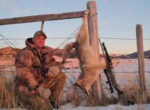 Troy Adams with one of his many coyote catches right as the sun sets in Montana.