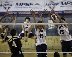 Taylor Sander (15) and Devin Young (19) leap for a block in a game at the Smith Fieldhouse. Photo by Elliott Miller.