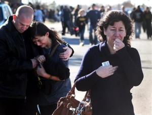 A woman waits at a staging ground area where families are being reunited with Berrendo Middle School students after a shooting at the school, Tuesday, Jan. 14, 2014, in Roswell, N.M. (AP Photo)