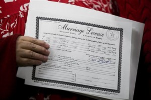 Shelly Eyre, left, holds the marriage license just issued to her and her partner Cheryl Haws at the Utah County Clerk's office in Provo, Utah on Thursday, Dec. 26, 2013. (AP Photo/The Daily Herald, Mark Johnston)