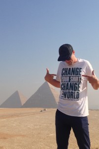A Revive Service Tours employee shows off his new shirt in front of the Pyramids in Egypt. Shirts are part of a new campaign by Revive Service Tours. Photo Courtesy of Revive Service Tours