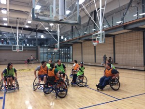 A group of people in a scrimmage of wheelchair basketball. (Photo courtesy of Haylin Martin.) 