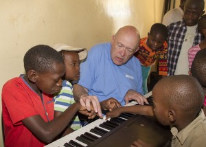 Randy Boothe teaches children to play the keyboard at the SOS Children's Home in Gabarone, Botswana, as part of a Young Ambassador tour. (Photo by Mark A. Philibrick/BYU Photo.)
