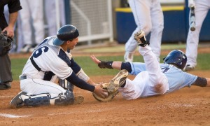 BYU catcher Jarrett Jarvis tags a Torero out as he slides home. The Cougars will play the third and final game against foe San Diego tomorrow at 1 p.m.