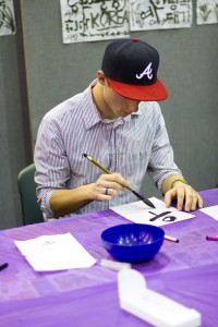 A student learns Korean calligraphy during Friday night's Korean Fair.