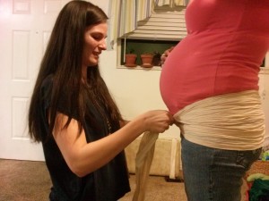 Madison Lopez demonstrates hip binding to a client. Lopez will wrap her client's stomach postpartum to help get her body back to normal.  Photo Courtesy of: Madison Lopez