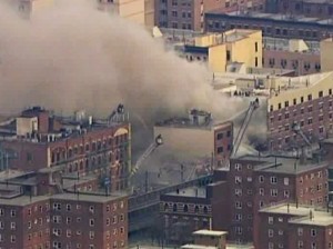 In this image taken from video from WABC, firefighters battle a blaze at the site of a possible explosion and building collapse in the East Harlem neighborhood of New York, Wednesday, March 12, 2014. (AP Photo/WABC-TV)