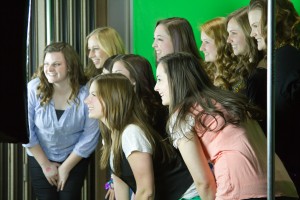 Students took photos in front of a green back drop to compliment the New Orleans theme  [Photo By Sarah Hill].
