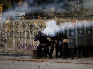 Bolivarian national police officers fire teargas at demonstrators during clashes in Caracas, Venezuela, Wednesday, March 5, 2014 (Photo Courtesy Associated Press).