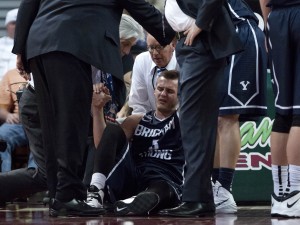 Kyle Collinsworth gets help walking off the court after sustaining a knee injury during Tuesday's WCC Championship game against Gonzaga. Photo by Elliott Miller 