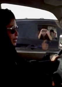FILE - In this file image made from Wednesday, June 22, 2011 video released by Saudi Women for Driving via Change.org, a website used by activist groups, the passenger of a passing vehicle looks across as Azza Al-Shamasi drives a car as part of a campaign to defy Saudi Arabia's ban on women driving, in Riyadh, Saudi Arabia (Photo Courtesy Associated Press). 
