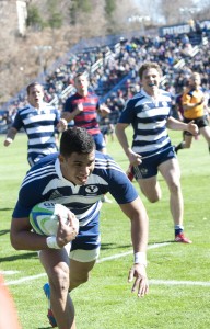 A large home crowd cheers on BYU rugby player Joshua Whippy as he dives for five points against St. Mary's. Photo by Natalie Stoker