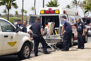 A 16-year-old boy, seen sitting on a stretcher center, who stowed away in the wheel well of a flight from San Jose, Calif., to Maui is loaded into an ambulance at Kahului Airport in Kahului, Maui, Hawaii Sunday afternoon, April 20, 2014. (AP Photo)