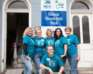 Page Holland (center) stands with other Habitat for Humanity volunteers. (Photo by Elliott Miller)