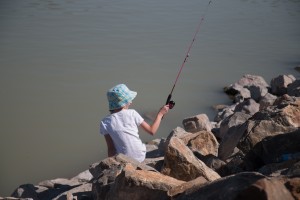 A local girl fishes at Utah Lake on Saturday during the free statewide fishing day. Photo by Maddi Dayton.