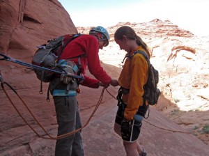 Jewell does a safety check on Throolin before a rappel in Hogwarts Canyon. 