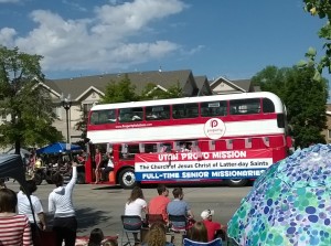LDS Senior Missionaries from the Utah Provo Mission wave to the crowd from a double-decker bus at Provo's Grand Parade. (Photo by Donovan C Baltich
