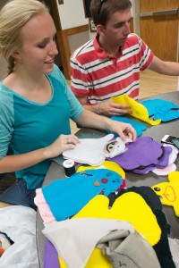 Students Kalisha Foy and Trent Taylor sew puppets for Y-Serve's Service to the World activity. These puppets are easy to pack and transport to other countries making them a great service project toy. (Elliott Miller)