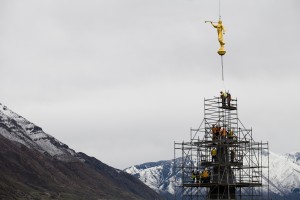On Monday, March 31, 2014, workers placed the Angel Moroni statue atop the Provo City Center Temple, signaling the site's transition from a tabernacle to a temple. (AP Photo/The Daily Herald, Mark Johnston)