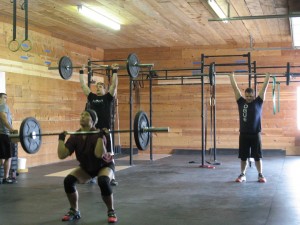 CrossFit coach Benjamin Johnson (far left) watches the form of his Crossfit class during a workout in Springville. 