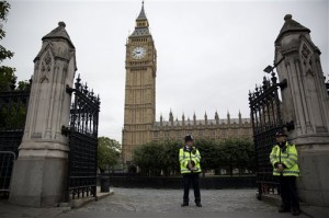British police officers stand guard outside the Houses of Parliament in London, Monday, Sept. 1, 2014.  Britain's Prime Minister David Cameron is expected on Monday to expand powers to combat terrorism in hopes of preventing attacks by Islamist militants returning from terror training in the Middle East.  AP Photo/Matt Dunham