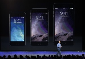 Phil Schiller, Apple's senior vice president of worldwide product marketing, discusses the new iPhone 6, center, and iPhone 6 plus, right, on Tuesday, Sept. 9, 2014, in Cupertino, Calif. (AP Photo/Marcio Jose Sanchez)
