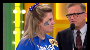 Drew Carey explains to Shaylie Fawcett the rules for her game, "Secret 'X,'" in this screenshot. (Photo courtesy CBS)