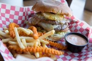 Rumbi's Kahuna burger has lettuce, tomato, Swiss cheese and pineapple. It's drizzled with Teriyaki sauce. (Elliott Miller)