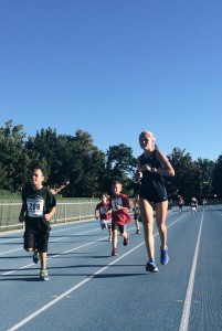 BYU cougar runs alongside the young racers 