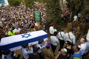 In this file photo taken Sunday, Aug. 3, 2014, Israeli soldiers carry the coffin of Israeli Army 2nd. Lt. Hadar Goldin during his funeral at the military cemetery in the central Israeli city of Kfar Saba. The third Gaza War in six years appears to have ended in another sort of tie, with both Israel and Hamas claiming the upper hand. Their questionable achievements have come at a big price, especially to long-suffering Palestinians in Gaza. (AP Photo/Oded Balilty, File)