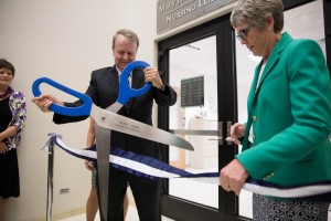 Rex Rawlinson cuts the ribbon for the formal opening of the Mary Jane Rawlinson Geertsen Nursing Learning Center. (Elliot Miller)